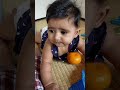 Cute baby eating orange 1st time.