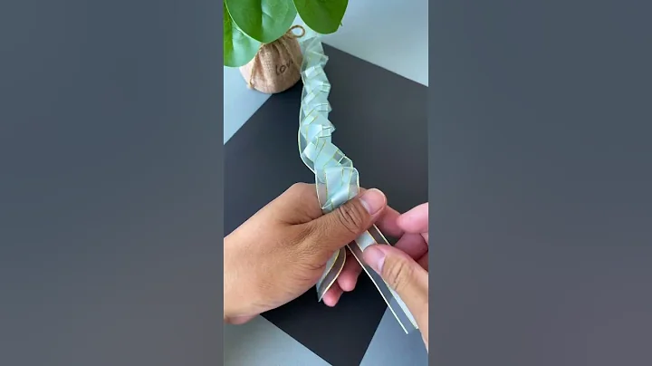 A ribbon is folded and pulled to become a beautiful rose flower. DIY handmade kindergarten handm