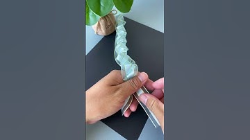 Thumbnail of A ribbon is folded and pulled to become a beautiful rose flower. DIY handmade kindergarten handm