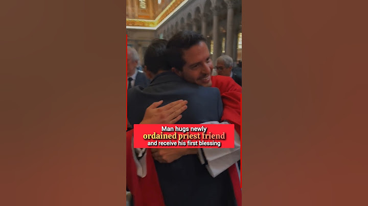Man hugs newly ordained priest friend after receiving his first blessing #priest #bishop #reverend