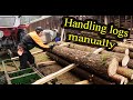 Loading and stacking logs manually for the sawmill