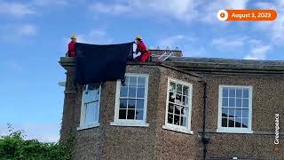 Protesters drape UK PM's home in black over oil policy
