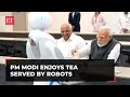 Gujarat pm modi enjoys cup of tea served by the robots at science city ahmedabad