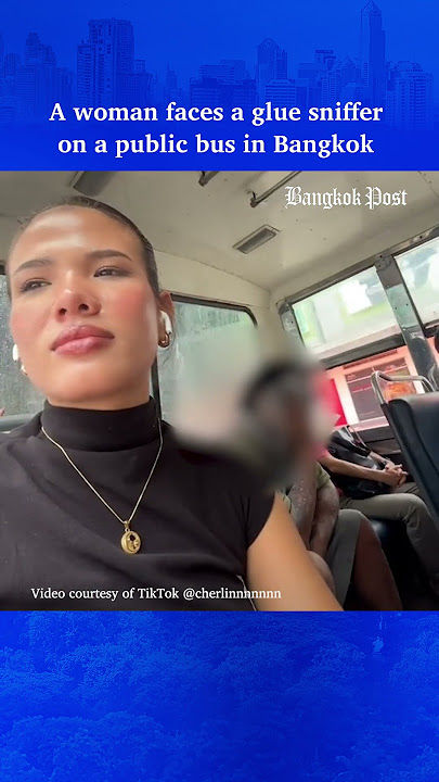 A woman faces a glue sniffer on a public bus in Bangkok