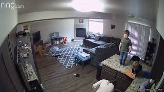 Kids play on kitchen counter/island then little girl falls and faceplants on floor (Security camera)