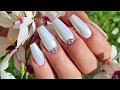 Watch me doing my nails in white with chrome and Swarovski crystals.