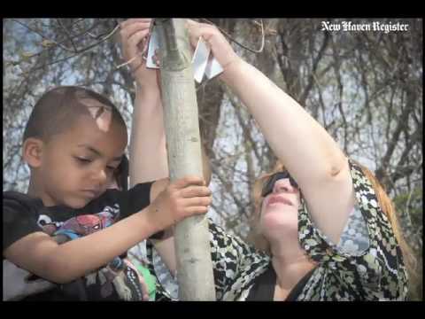 Planting a tree in honor of slain Common Ground High School student Javier Martinez.