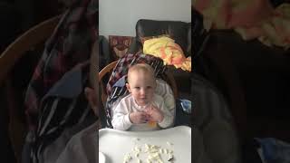 Guy throws American cheese at boy seated in high chair