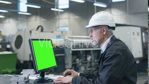 Senior Engineer in Glasses is Working on a Desktop Computer with Green Screen | VideoHive 15142117