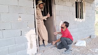 A helping hand: building a dream house, putting daffodil on the door and window