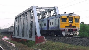 High speed conventional EMU local trains crossing over a rail bridge