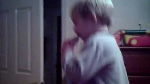 Boy Eating A Bagel And Dancing