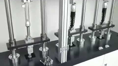 Multi-station spring fatigue testing machine