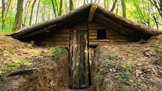 A man built a shelter in the forest, makes doors and a window