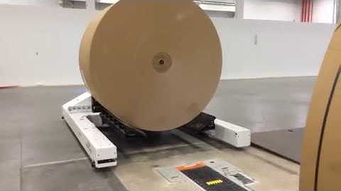 AGV Roll loading to Harmax automatic floor conveyor