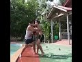 This is the moment two man fight by the side of the pool