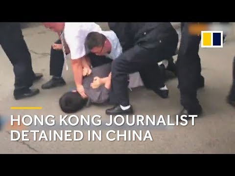 Hong Kong journalist handcuffed and dragged into police van in China