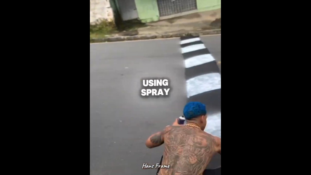 This man is making a fake speed bump.😂 