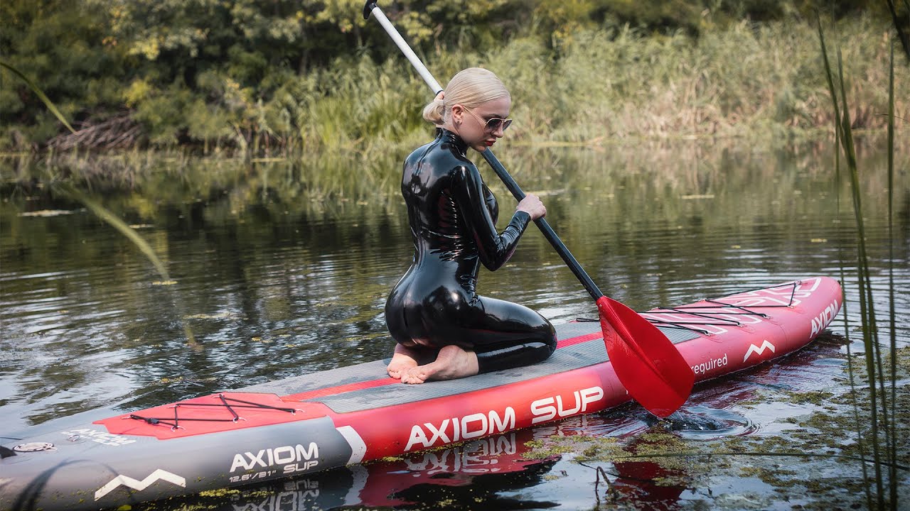 In latex catsuit at the SUP board