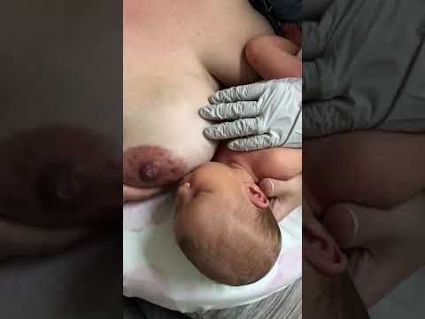 Sleepy baby at the breast