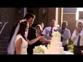 Newlywed couple cutting their wedding cake.