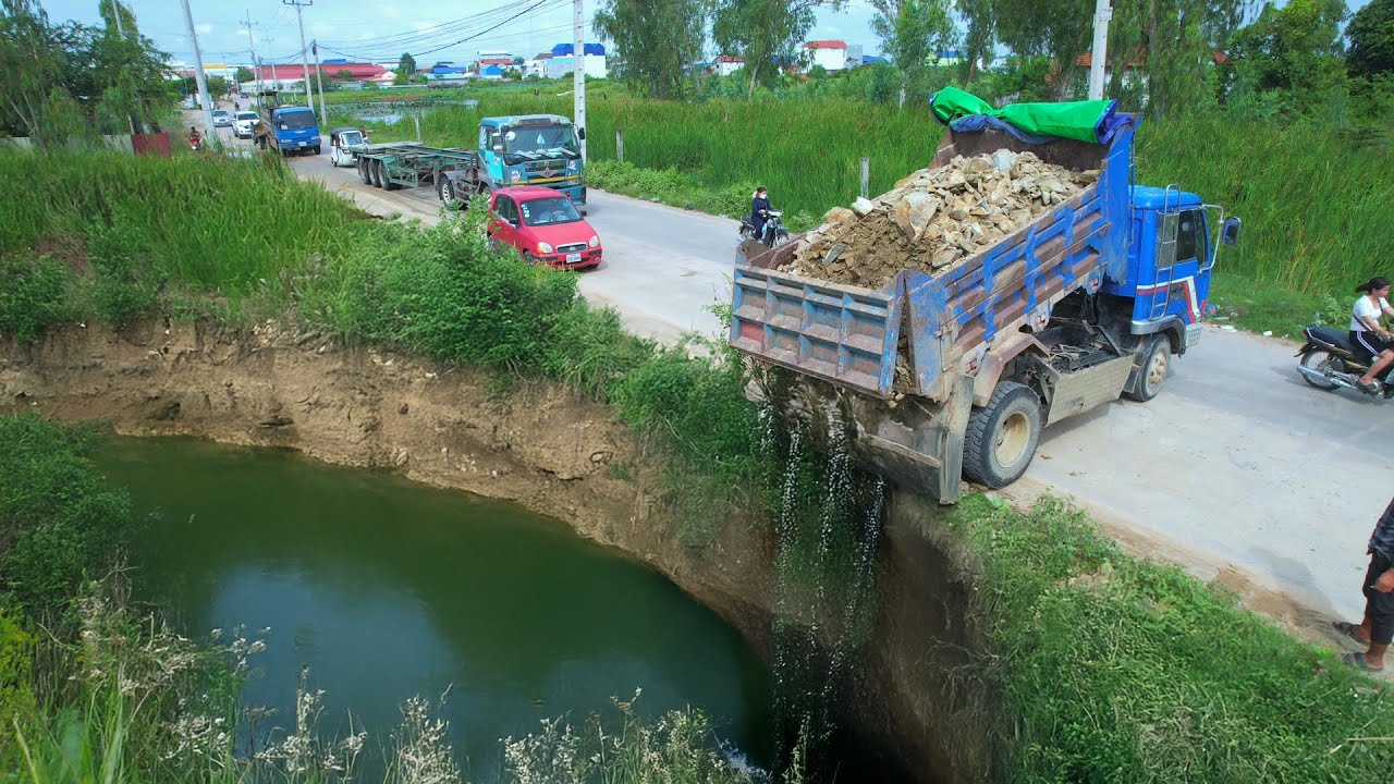 Dump Truck Dumping Soil a Deep pond Hidden Pollution