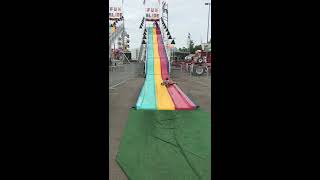 Boy goes down fun slide in sack then bumps his head on edge