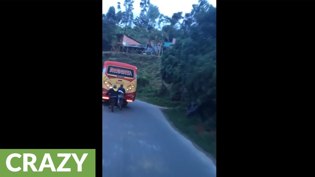 Kids on bikes hitch ride from back of bus - YouTube