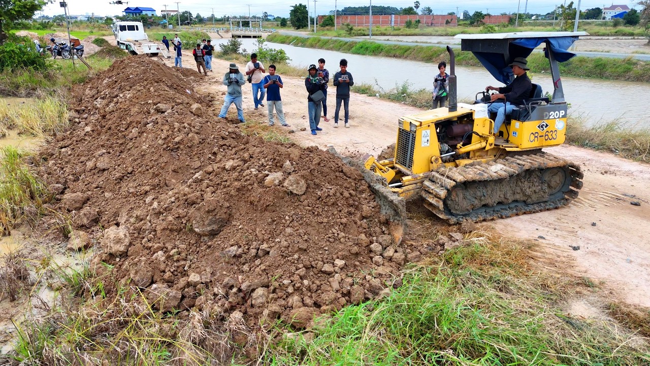 Professional teamwork action! Dump trucks and dozer working together smoothly to move stone and soil