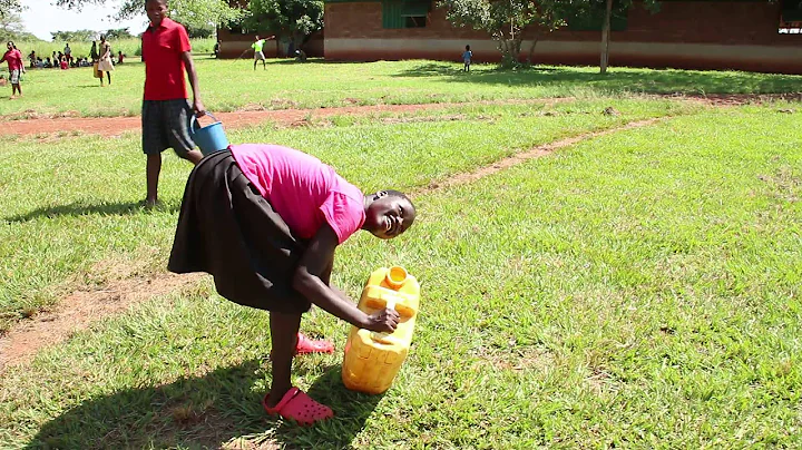 Uganda Girl Carries Water On Head