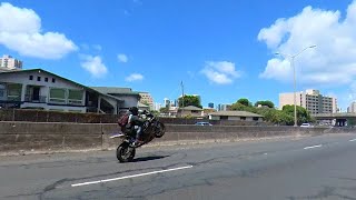 guy does wheelie on highway