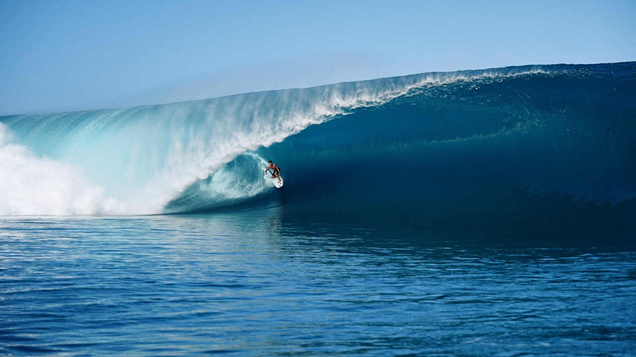 Surfer catching a wave at Teahupo'o Tahiti
