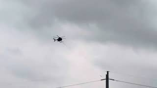 Helicopter stretching power lines across interstate