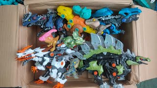 Box full of Various Dinosaurs and robot dinosaurs, velociraptor, T rex, triceratop, Jurassic world10