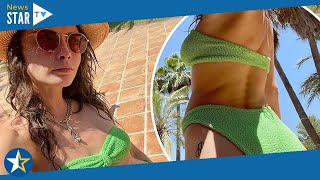 Cara Delevingne displays her incredible bikini body and pert posterior in strapless green two-piece