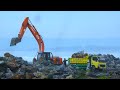 Excavators Dump Trucks Rock Wall On The Beach