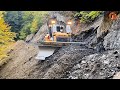 Skillful excavator operators are building roads on a steep mountain