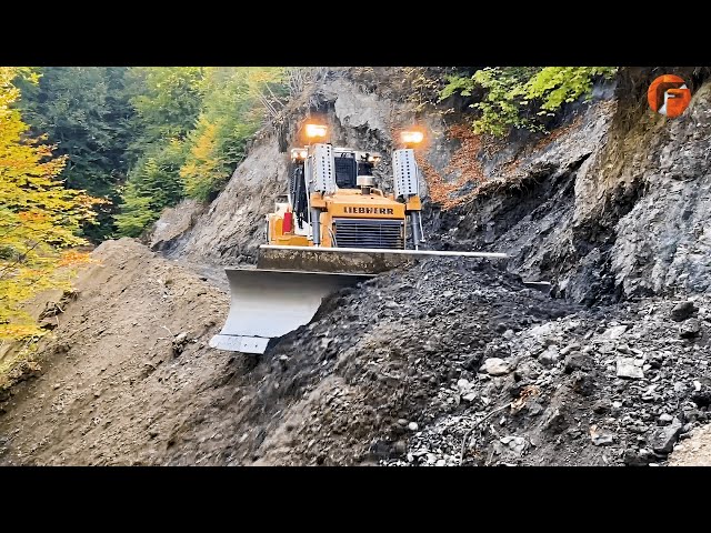 Skillful Excavator Operators are Building Roads on a Steep Mountain class=