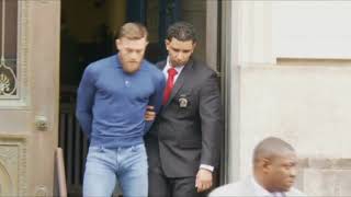 UFC fighter Conor McGregor escorted by police from court