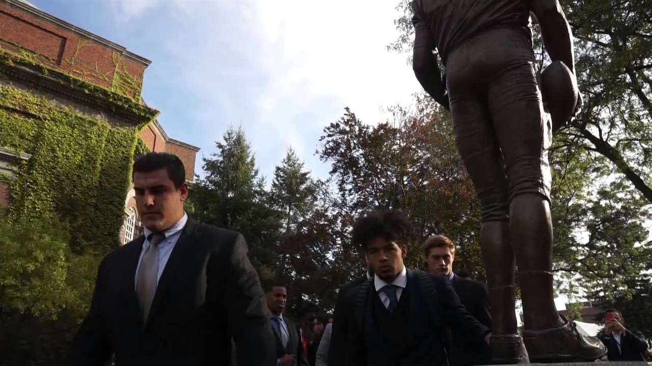 Syracuse football players touch Ernie Davis statue as part of pregame ritual