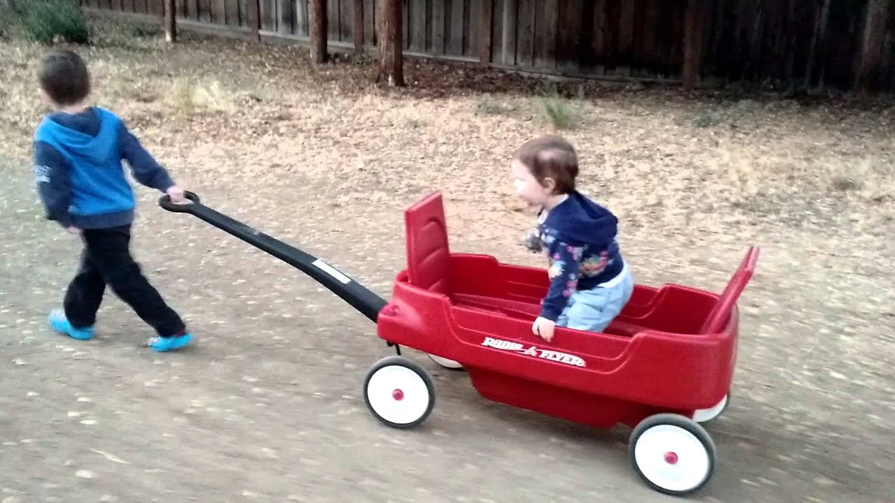 Big brother pulling little sister in wagon - YouTube