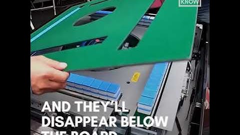 Electronic mahjong table automatically shuffles and stacks tiles for each game