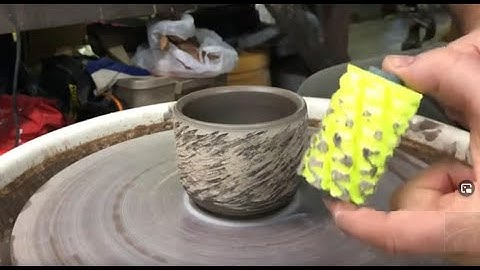 Using a texture roller diagonally on a thrown pot