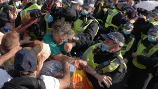 British Police Officer Punches Protester...but Protester Punches Back