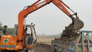 Excavator loading mud in Traly