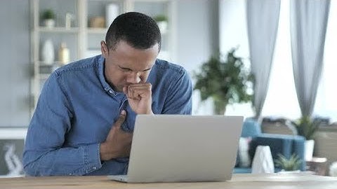 Sick Young African Man Coughing at Work, Cough | Stock Footage - Videohive