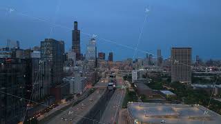 Evening traffic on Kennedy Expressway moving towards downtown Chicago skyline with Willis Tower