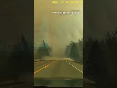 Dashcam video shows family escaping wildfire in Canada.