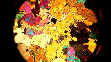 A thin section viewed through a petrographic microscope with stage rotation