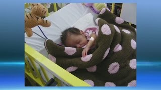 Former NICU baby now 7 years old, giving back with blanket and book drive